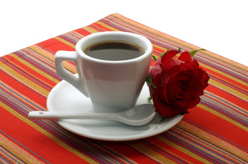 white cup of coffee with a red rose on white background