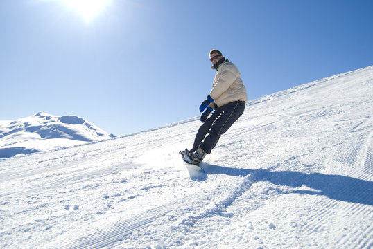 Snowboarding in a bright sunny day stock photo