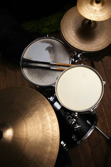 drum set in dramatic light on a black background