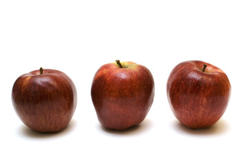 Three red apples on the white background