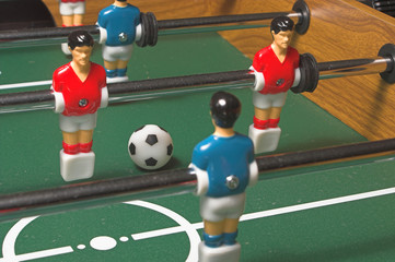 A miniature tabletop foosball arcade type game.