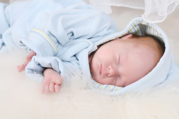 Small kid sleeps and smile in his dreams