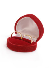 Red suede box with two golden wedding rings