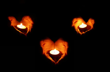 three couples of heart-shaped palms with candles 