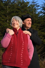 Fototapeta premium Senior couple walking in a pine forrest.