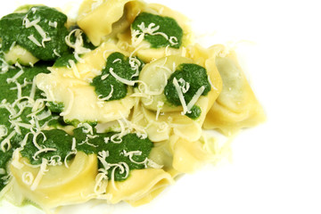 Spinach tortellini served with cheese. Italian cuisine.