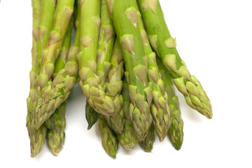 Fresh green asparagus on a white background with shallow DOF