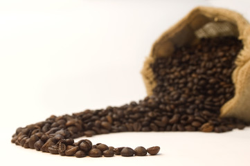 Burlap bag with a stream of coffee beans