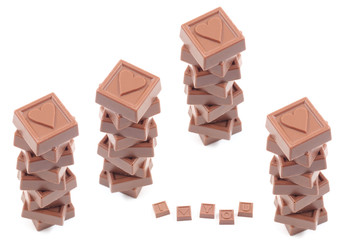 stack of delicious chocolates with heart isolated on white