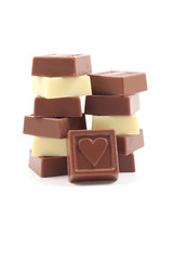 stack of delicious chocolates with heart isolated on white