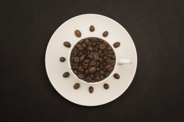 Coffee cup full of coffee beans. Breakfast time!