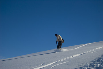 Winter snowboarding fun in a bright sunny day stock photo