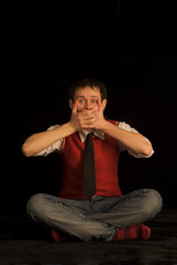 Young man on the black background. 