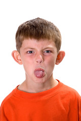 Young boy sticking out his tongue on a white background