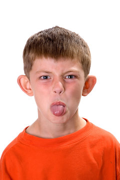 Young boy sticking out his tongue on a white background