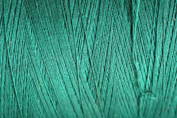 teal thread fabric wool yarn wrapped in a spool