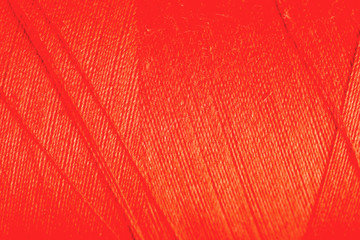 orange thread fabric wool yarn wrapped in a spool