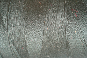 grey thread fabric wool yarn wrapped in a spool
