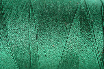 navey green thread fabric wool yarn wrapped in a spool