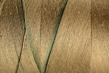 green thread fabric wool yarn wrapped in a spool