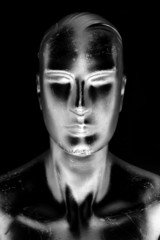 futuristic manikin man in silvery shadows of black