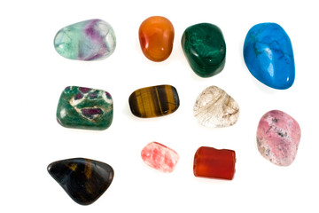 Multi-coloured ornamental stones on a white background