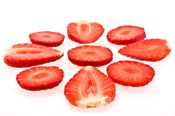 Slices of a ripe strawberry on a white background