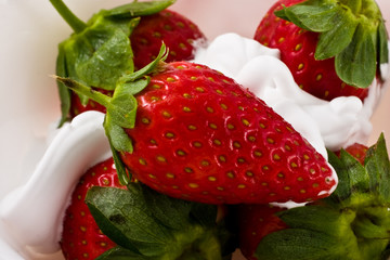 Berries of a ripe strawberry with whipped cream