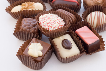 Close up of various colorful chocolat bonbons isolated on white
