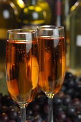 Two flutes of golden wine in a bar