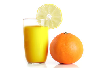 orange juice in a glass and an orange isolated