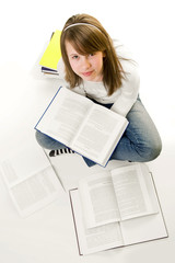 Obraz premium Portrait of Happy young schoolgirl reading books