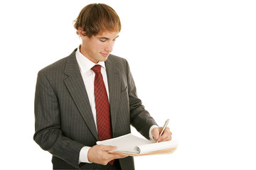 Handsome young businessman taking notes.  