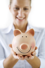 smiling female holding piggy-bank