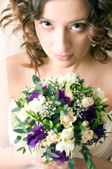 enigmatic stunning gorgeous bride with bunch of flowers