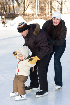 Winter Recreation. Family Skating On Rink