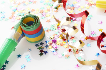 red and golden ribbons and small confetti stars, party time