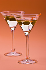 two bocal of martini with olive over orange