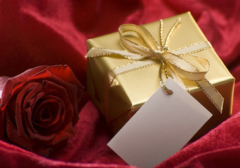 golden present with red rose close up shoot