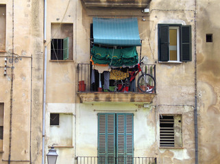 Encumbered balcony at old dirty house 