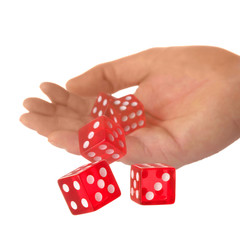 Five red dice being thrown from a hand, shallow DOF.