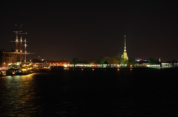 night view on illuminated ship and petropavlovskaya krepost