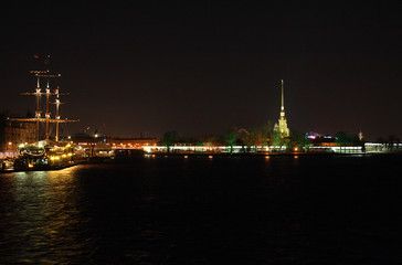 Fototapeta premium night view on illuminated ship and petropavlovskaya krepost