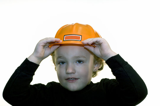 Young boy wearing orange construction hard hat