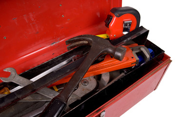 Naklejka premium Old used and rusty tools in a red toolbox 