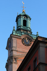 Stockholm Clock Tower in old town on blue sky. Sweden