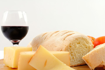 Bread and Cheese food with a wine glass.