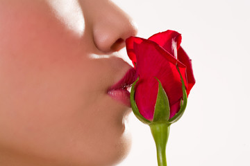 close up of a lady kissing a rose