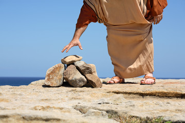 Man picking up stone.  Concept - Sin, punishment