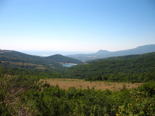 Mountain lake. Wood on mountain hill